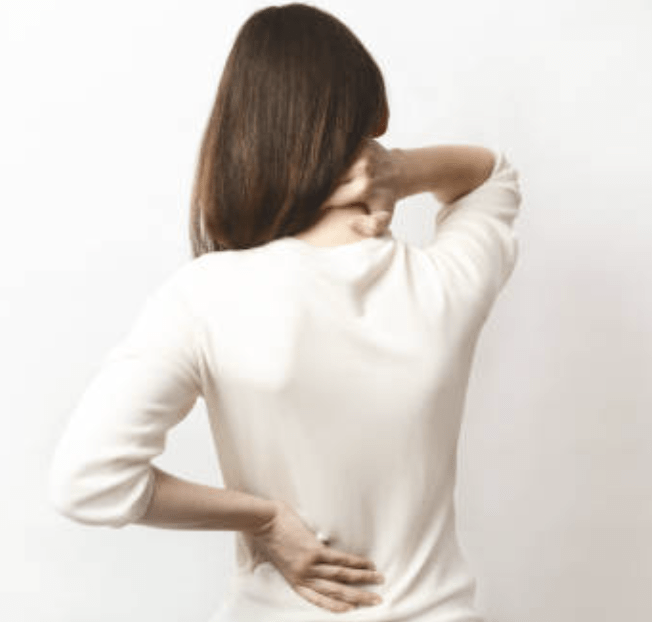 woman with back pain holding back and neck